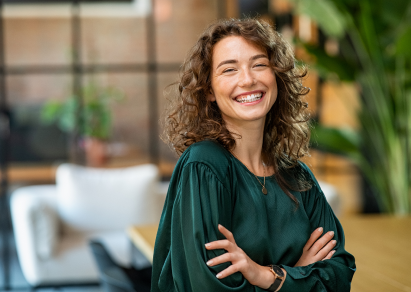 Women looking into camera with arms crossed smiling