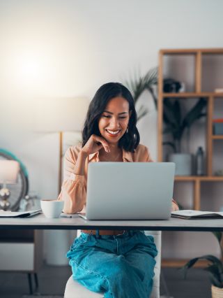 Woman smiling and looking at her laptop