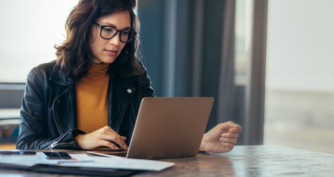 A woman browsing on her laptop