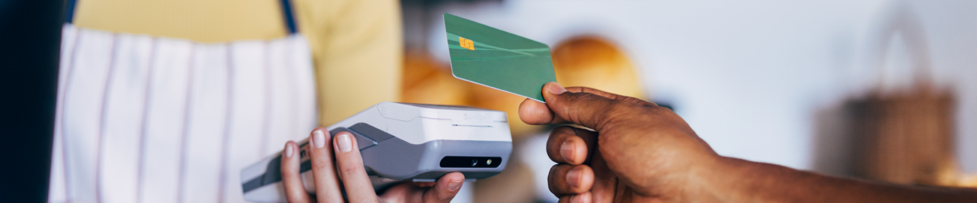 Customer using a debit card at a bakery, showcasing convenient and secure everyday purchases.