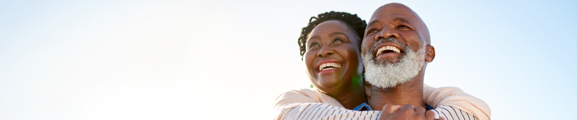 Happy couple smiling together, representing financial confidence and shared goals.