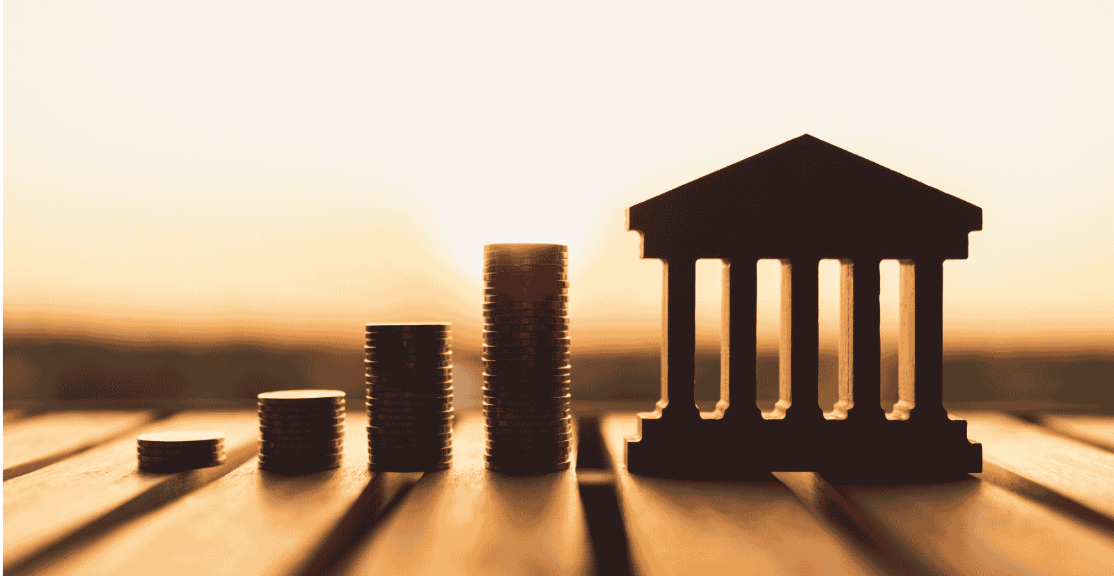 Illustration of a bank symbol with stacked coins representing key financial concepts such as interest rates, inflation, deflation, and savings