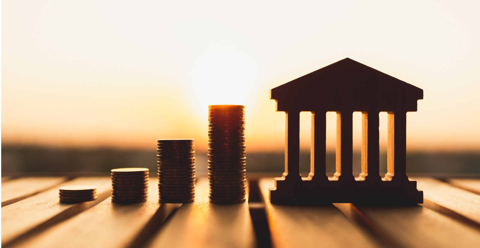 Bank icon with stacked coins representing savings, inflation, and interest rates in today’s economy.